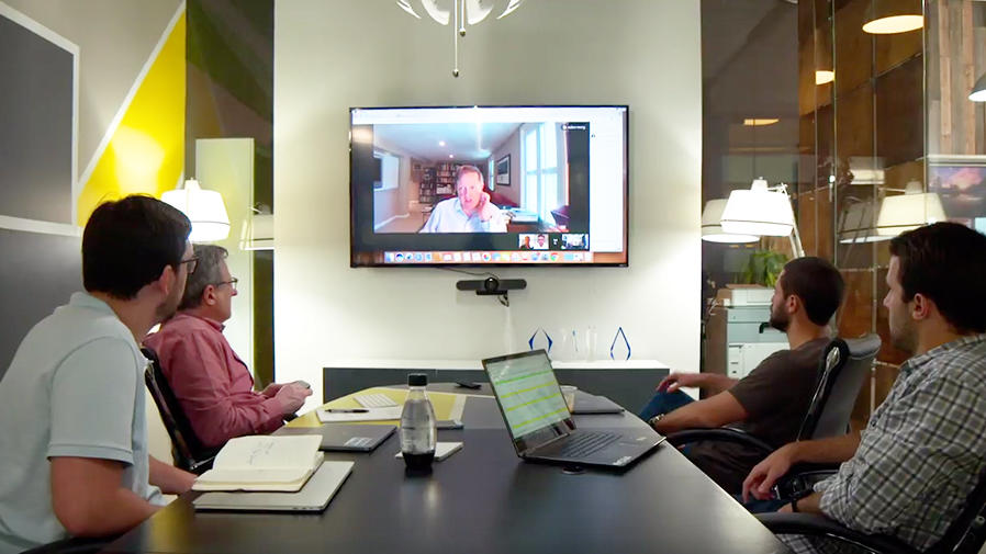 People around video conference table